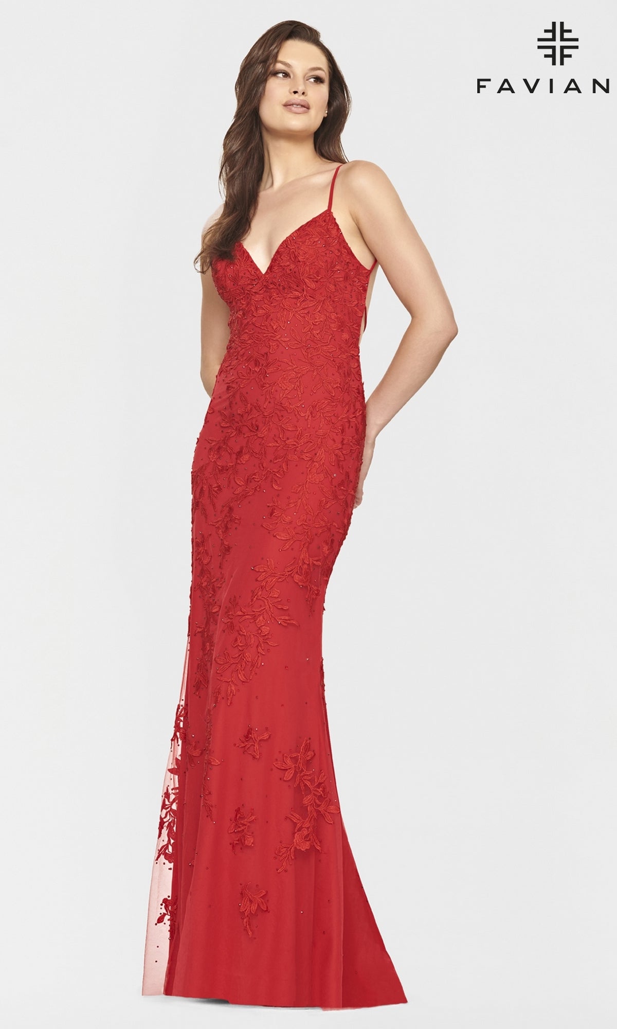 A woman wears the Faviana Lace Embroidery Long Backless Prom Dress—a red, floor-length gown with thin straps—standing against a plain white background.